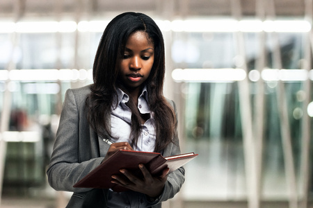 Portrait of a woman writing on a notebookの写真素材