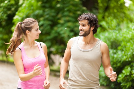 Couple running in a parkの写真素材