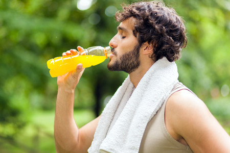 Young man drinking after sportの写真素材