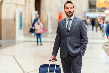 Man walking with a trolley at the stationの写真素材