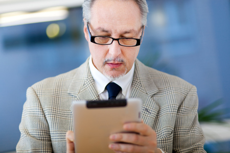 Mature businessman at work in the officeの写真素材