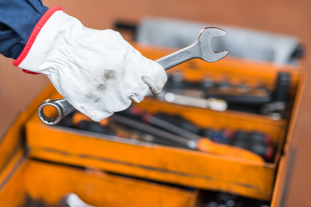 Mechanic's hand holding a wrench