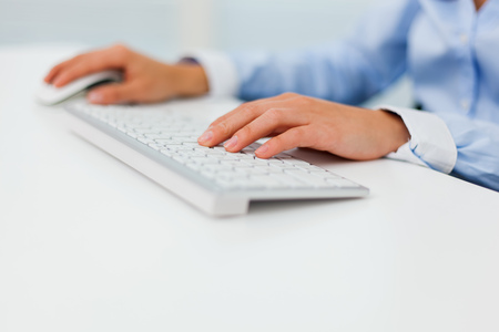 male hands typing on a laptop の写真素材