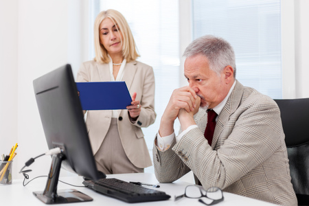 Business colleagues working with a laptopの写真素材