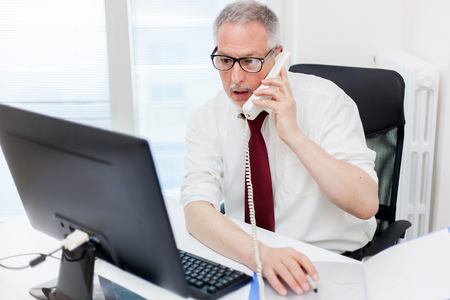 Senior businessman on the phoneの写真素材