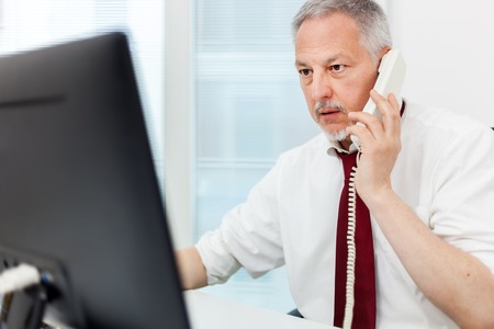 Smiling businessman talking on the phoneの写真素材