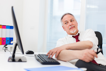 Senior businessman working with his computerの写真素材