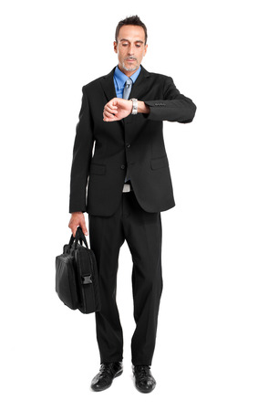 Businessman checking his clock isolated on whiteの写真素材