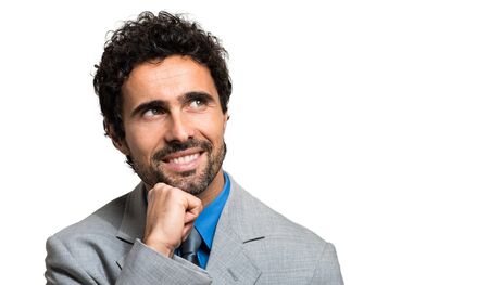 Closeup of a pensive young business man, isolated on whiteの写真素材
