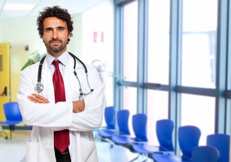 Portrait of a smiling handsome doctorの写真素材