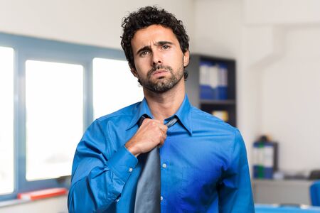 Sweating businessman due to hot climateの写真素材