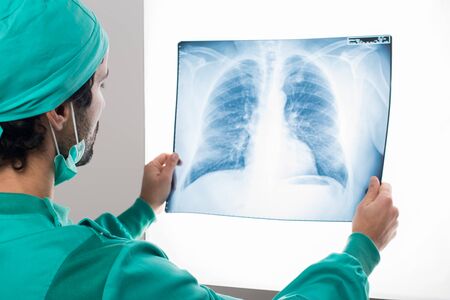 Surgeon analyzing a lung radiographyの写真素材