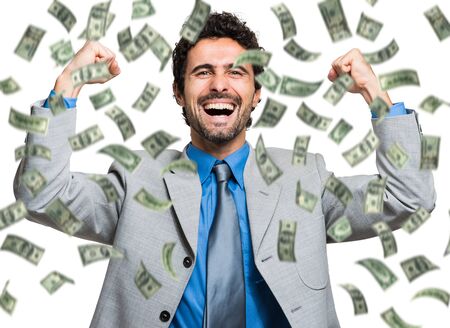 Happy man enjoying the rain of moneyの写真素材