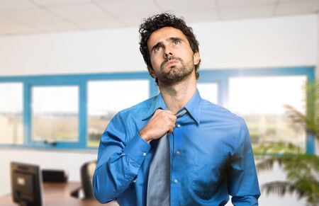 Sweating businessman due to hot climateの写真素材