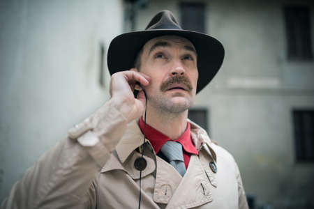 Detective listening from his ear budsの写真素材