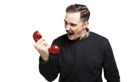 Angry man shouting at the phoneの写真素材