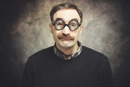 Funny portrait of a ner mand wearing nerd glassesの写真素材