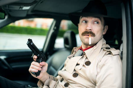 Detective waiting for someone in his carの写真素材