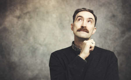 Mature man in a pensive expressionの写真素材