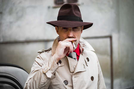 Vintage detective tuxedo at cigarette ina city slumの写真素材