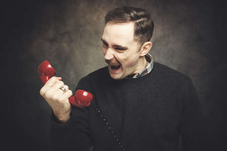Angry man shouting at the phoneの写真素材