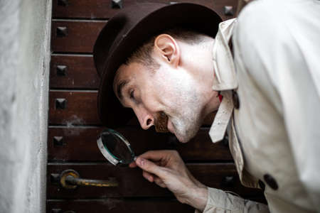 Detective using a magnify lensの写真素材