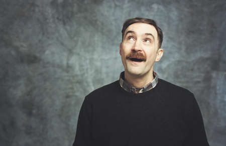 Mature man in a pensive expressionの写真素材