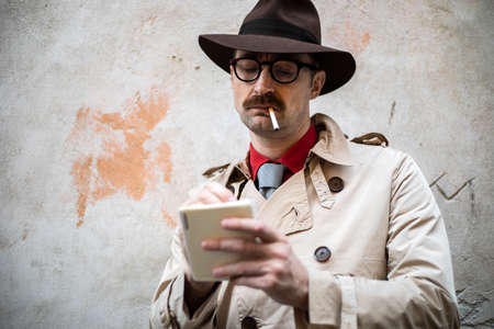 Detective taking notes in a ghettoの写真素材