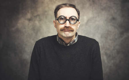 Funny portrait of a ner mand wearing nerd glassesの写真素材