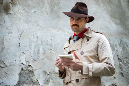 Detective taking notes in a ghettoの写真素材