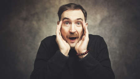 Portriat of a mature man in an amazed expressionの写真素材