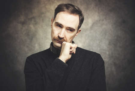 Mature man in a pensive expressionの写真素材