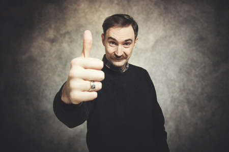 Handsome senior man showing thumbs upの写真素材
