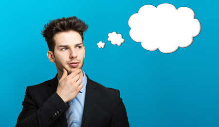 Thoughtful businessman isolated on whiteの写真素材
