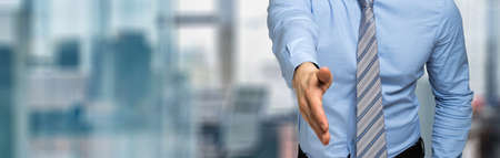 Young manager giving you a handshakeの写真素材