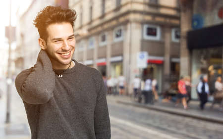 Smiling handsome man walking in the cityの写真素材