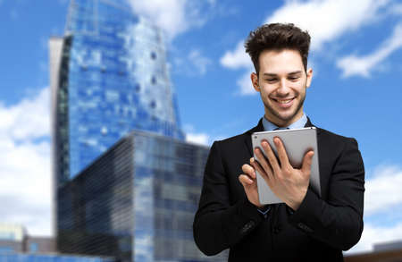 Young manager using a digital tablet outdoorの写真素材