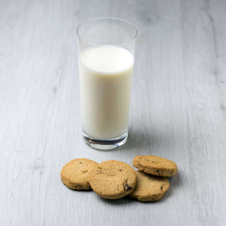 Chocolate homemade pastry cookies on a bright wooden tableの写真素材