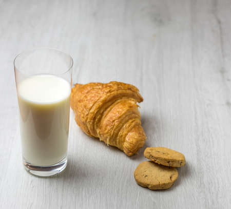 A croissant and a glass of milkの写真素材