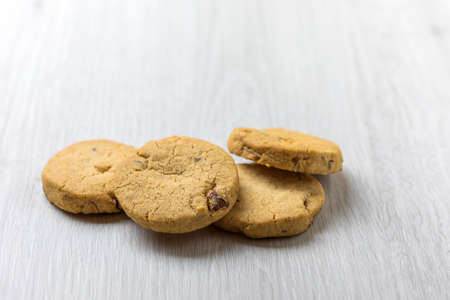 Chocolate homemade pastry cookies on a bright wooden tableの写真素材