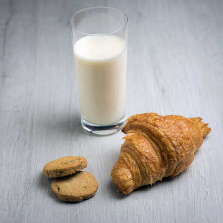 A croissant and a glass of milkの写真素材