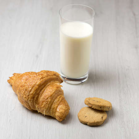 A croissant and a glass of milkの写真素材