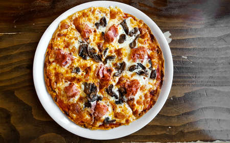 Italian fast food. Pizza with ham and mushrooms, top view. Photo menu.の写真素材