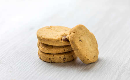 Chocolate homemade pastry cookies on a bright wooden tableの写真素材
