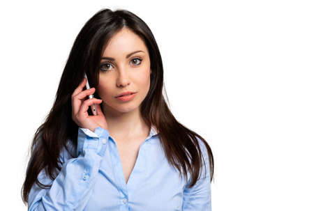Successful businesswoman with cell phone, isolated on white backgroundの写真素材