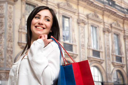 Smiling woman holding shopping bagsの写真素材