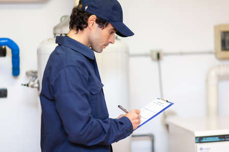 Technician servicing an hot-water heaterの写真素材