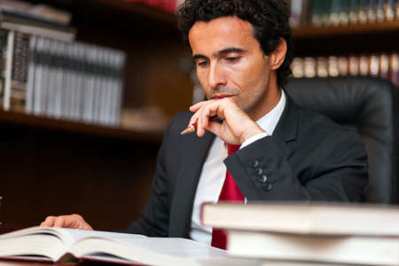 Young lawyer reading a bookの写真素材