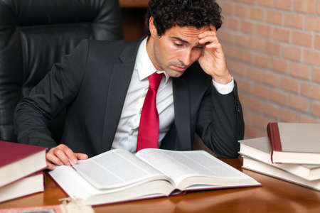 Young lawyer reading a bookの写真素材
