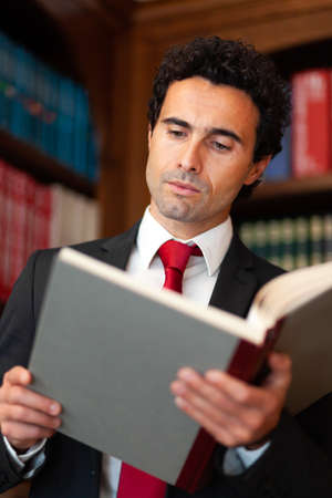 Lawyer reading a book in his studioの写真素材